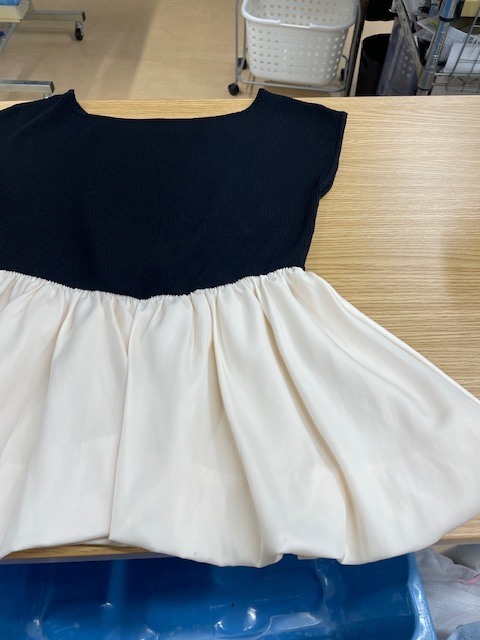 上半分が黒い面で下半分が白いレーヨンフレアになっているトップスの白い部分に付いたヘアカラーがキレイに落ちた染み抜きクリーニング事例(３，９６０円税込）2026.07.18